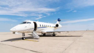 Bombardier Challenger aircraft sitting on a runway with the stairs open.